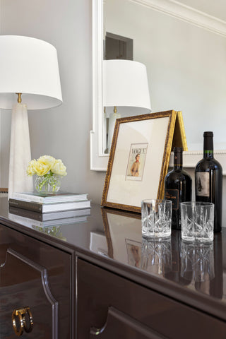 An elegantly styled banquet piece with a mirror above.