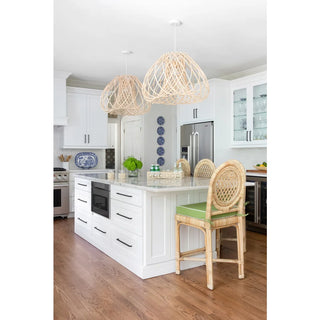 Louis XVI Stools with green cushions in a white kitchen.
